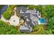 Aerial view featuring stunning mansion with circle driveway, pool, and beautiful landscape at 9005 Old Southwick Pass, Alpharetta, GA 30022