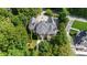 Aerial view showcasing luxurious home with a private driveway and manicured lawn at 9005 Old Southwick Pass, Alpharetta, GA 30022