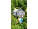 Aerial view of an expansive home featuring a pool and a lush green yard surrounded by trees at 9005 Old Southwick Pass, Alpharetta, GA 30022