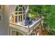 A top-down view of the balcony featuring an outdoor dining set and overlooking a yard full of trees at 9005 Old Southwick Pass, Alpharetta, GA 30022