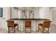 Stylish bar area features a granite countertop and seating for three at 9005 Old Southwick Pass, Alpharetta, GA 30022