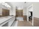 Spacious bathroom features double sinks, a large mirror, and a shower with gold trim at 9005 Old Southwick Pass, Alpharetta, GA 30022