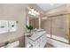 Bathroom with a white vanity, gold hardware and a shower with gold trim and glass doors at 9005 Old Southwick Pass, Alpharetta, GA 30022