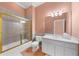 Bathroom featuring tiled walls, glass shower door, white cabinets, and toilet at 9005 Old Southwick Pass, Alpharetta, GA 30022