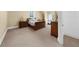 This bedroom is spacious with beige carpet and has a bed with beautiful wooden furniture at 9005 Old Southwick Pass, Alpharetta, GA 30022