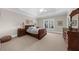Bedroom with tray ceiling, neutral paint and large window with plantation shutters at 9005 Old Southwick Pass, Alpharetta, GA 30022