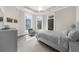 Cozy bedroom features a comfortable bed, ample natural light, and a window seat at 9005 Old Southwick Pass, Alpharetta, GA 30022