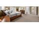 Spacious carpeted bedroom with a traditional sleigh bed and coordinating wood furniture at 9005 Old Southwick Pass, Alpharetta, GA 30022