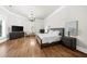 A large bedroom with hardwood floors, a tray ceiling and plenty of natural light at 9005 Old Southwick Pass, Alpharetta, GA 30022