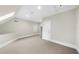 Bonus room with carpet, natural light, and an access door to attic storage at 9005 Old Southwick Pass, Alpharetta, GA 30022