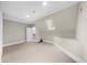Bonus room with carpet, natural light, and an access door to attic storage at 9005 Old Southwick Pass, Alpharetta, GA 30022
