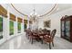 Elegant dining room with natural light, decorative chandelier and large table at 9005 Old Southwick Pass, Alpharetta, GA 30022
