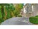 Long private driveway with landscaping leading to garages of the home at 9005 Old Southwick Pass, Alpharetta, GA 30022