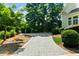 Driveway featuring custom walkway surrounded by bushes and manicured lawn at 9005 Old Southwick Pass, Alpharetta, GA 30022