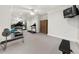 Well-equipped home gym with mirrored wall, workout equipment, and ceiling fan at 9005 Old Southwick Pass, Alpharetta, GA 30022