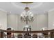Elegant foyer featuring a grand chandelier, staircase with wrought iron railings at 9005 Old Southwick Pass, Alpharetta, GA 30022