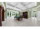 Spacious game room with a pool table, a bar area, and French doors leading to outdoor pool at 9005 Old Southwick Pass, Alpharetta, GA 30022