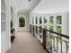 Hallway featuring large windows with lots of natural light and built in bookshelves at 9005 Old Southwick Pass, Alpharetta, GA 30022