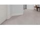 Hallway with plush carpet and white trim with an accent table and neutral paint at 9005 Old Southwick Pass, Alpharetta, GA 30022