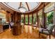 Office with wood paneling, built-in shelving, and a parquet floor under a dome ceiling, offering a traditional workspace at 9005 Old Southwick Pass, Alpharetta, GA 30022