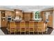 Open kitchen with hardwood cabinets and countertop seating at 9005 Old Southwick Pass, Alpharetta, GA 30022