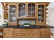 Hardwood cabinets with glass fronts and granite countertops provide ample storage at 9005 Old Southwick Pass, Alpharetta, GA 30022