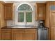 A kitchen sink with stainless steel appliances and hardwood cabinets at 9005 Old Southwick Pass, Alpharetta, GA 30022