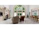 Beautiful living room featuring a fireplace, large windows, and bar seating at 9005 Old Southwick Pass, Alpharetta, GA 30022