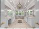 Luxurious main bathroom with dual vanities, a soaking tub, and natural light at 9005 Old Southwick Pass, Alpharetta, GA 30022