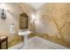 Elegant powder room featuring a pedestal sink, tasteful wall decor and sconce lighting at 9005 Old Southwick Pass, Alpharetta, GA 30022