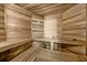 Relaxing home sauna with wooden benches and walls, a bucket and dipper, and thermometer at 9005 Old Southwick Pass, Alpharetta, GA 30022