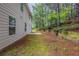 Wooded backyard with retaining wall and lush landscaping offers privacy at 450 Pinevale Ct, Atlanta, GA 30349