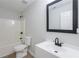 Bright bathroom features a shower-tub combo and modern sink at 450 Pinevale Ct, Atlanta, GA 30349