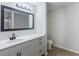 Bright bathroom featuring a white vanity with a black framed mirror and modern fixtures at 450 Pinevale Ct, Atlanta, GA 30349