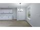 Bright dining area adjacent to kitchen with light fixture, window, and closet at 450 Pinevale Ct, Atlanta, GA 30349