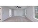 Spacious primary bedroom boasts plush carpet, neutral walls, ceiling fan and an adjoining ensuite bath at 450 Pinevale Ct, Atlanta, GA 30349