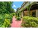 Beautiful backyard garden with brick pathway and lush greenery at 4540 Fourth Rail Ln, Cumming, GA 30040
