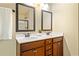 Bathroom with double sink vanity, granite counters, framed mirrors and tile floors at 4540 Fourth Rail Ln, Cumming, GA 30040