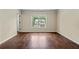 Inviting bedroom featuring hardwood floors, a large window and neutral paint colors at 4540 Fourth Rail Ln, Cumming, GA 30040