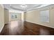 Large bedroom with hardwood floors, a tray ceiling, crown molding, and plenty of natural light at 4540 Fourth Rail Ln, Cumming, GA 30040