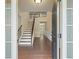 Inviting entryway with hardwood floors, a staircase, and natural light filtering through the windows at 4540 Fourth Rail Ln, Cumming, GA 30040