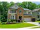 Charming two-story house with stone facade and lush landscaping at 4540 Fourth Rail Ln, Cumming, GA 30040
