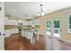 Well-lit kitchen featuring an island, modern appliances, granite countertops, and tile backsplash at 4540 Fourth Rail Ln, Cumming, GA 30040