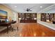 Cozy living room features built-in bookshelves and hardwood flooring at 4540 Fourth Rail Ln, Cumming, GA 30040