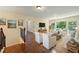 Bright living room features hardwood floors, natural light and neutral decor with ample seating at 4540 Fourth Rail Ln, Cumming, GA 30040