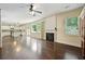 Open living area with a fireplace, hardwood floors, and views of the modern kitchen at 4540 Fourth Rail Ln, Cumming, GA 30040
