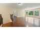 Spacious living room with hardwood floors, plenty of natural light, and a neutral color palette at 4540 Fourth Rail Ln, Cumming, GA 30040