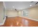 Spacious living room with hardwood floors and large window at 4540 Fourth Rail Ln, Cumming, GA 30040