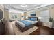 Main bedroom featuring a tray ceiling, large windows, and a sitting area with comfortable armchairs at 4540 Fourth Rail Ln, Cumming, GA 30040