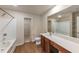 Bright bathroom featuring wood-look flooring, large vanity, and shower-tub combination with white tile surround at 513 Moline Way, Locust Grove, GA 30248